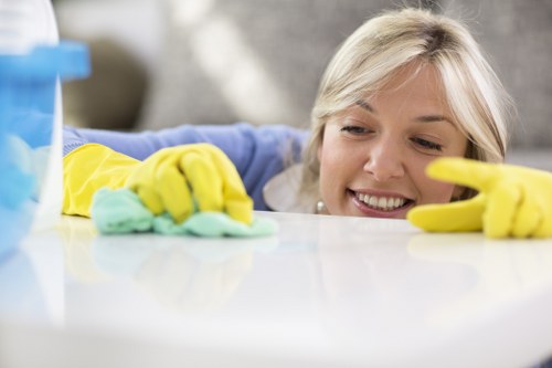 Local oven cleaner working in a compact Soho apartment kitchen