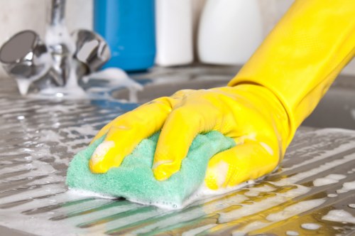 Cleaner tidying a compact flat near Soho and surrounding areas