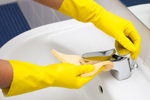 Professional cleaner wiping high-touch surfaces in a Soho office